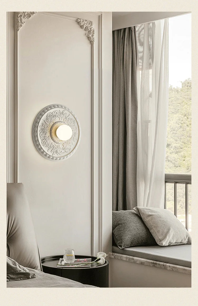 White retro French wall lamp beside a window nook, offering serene lighting for bedrooms or reading corners.