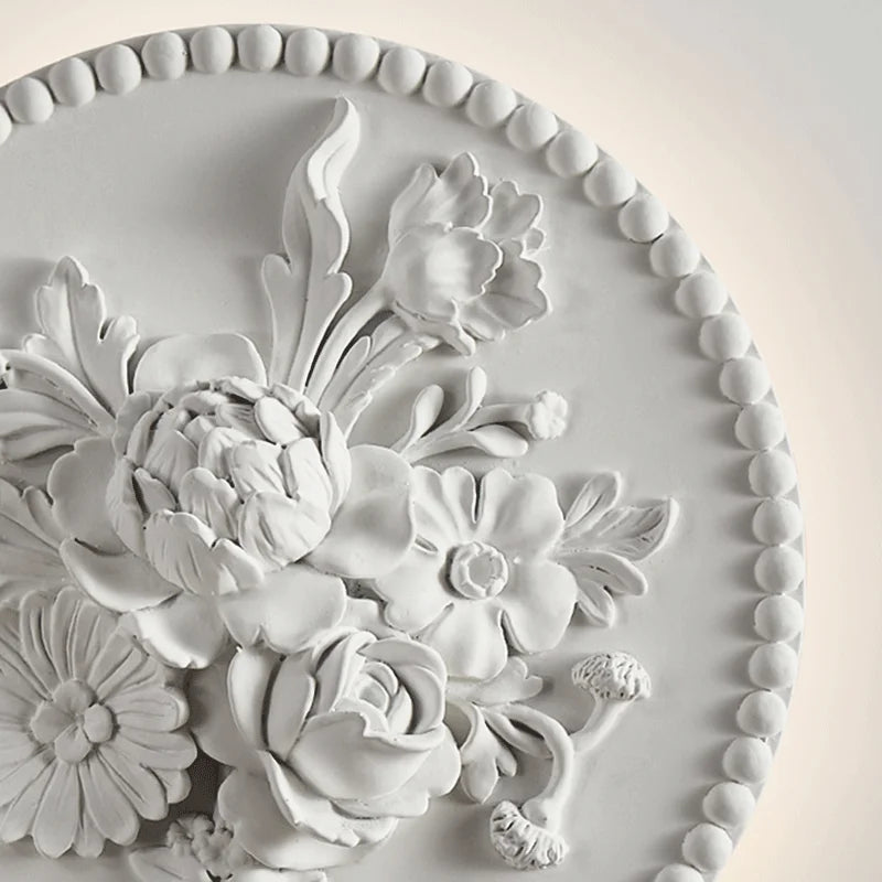 Close-up of French round vintage sconce showing detailed floral carvings and soft LED backlight, suitable for elegant wall lighting.