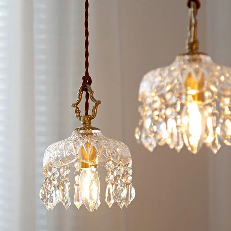 Pair of French Vintage Crystal Chandeliers - Copper Hanging Lamps casting warm glow, perfect for elegant home lighting.