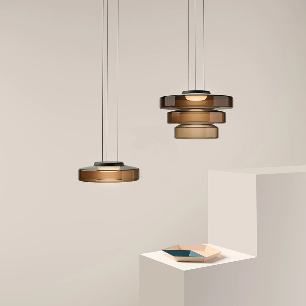 Amber glass pendant lights in single and multi-tier designs. Stylish lighting for contemporary kitchen or dining room decor.