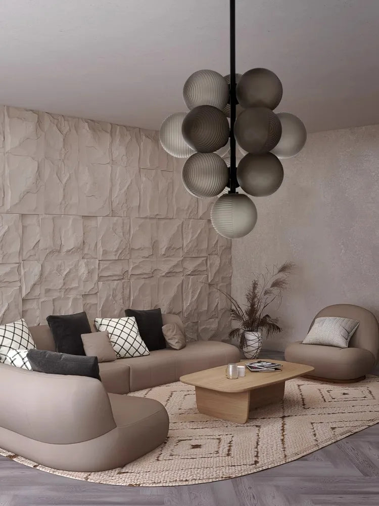 Grape Cluster LED Chandelier in grey glass hanging above a beige living room, adding a modern art deco touch to the space.