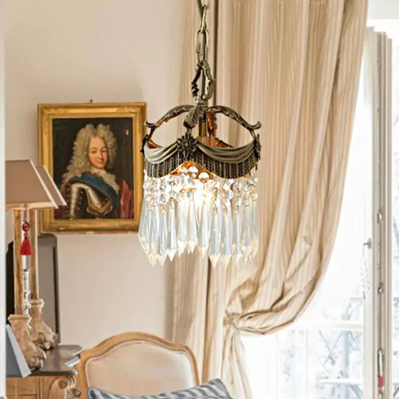 Green fabric French Velvet Tassel Chandelier hanging in a vintage-style living room, enhancing ambient lighting with crystal details.