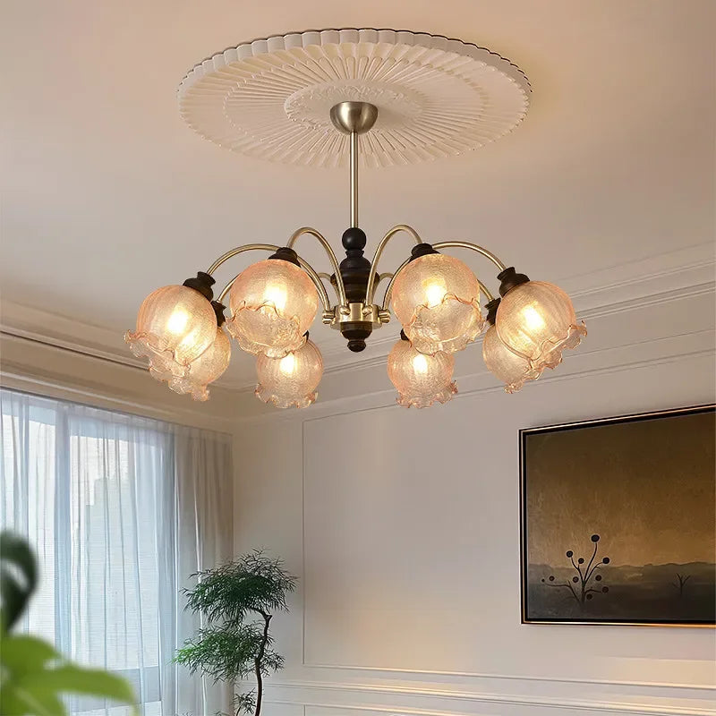 Elegant American chandelier with energy-efficient LED bulbs and ruffled crystal shades, enhancing a cozy living room ambiance.