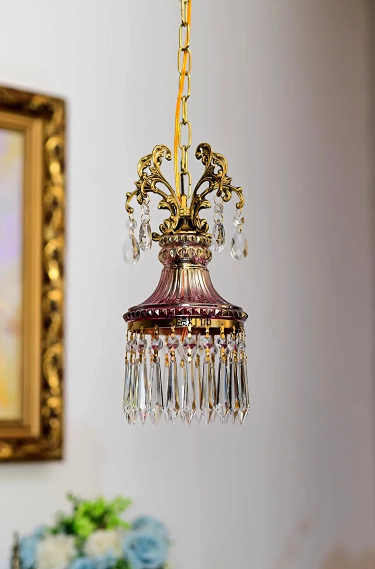 Ornate French crystal chandelier with gold scrollwork and hanging crystals, retro pendant light for classic interiors.