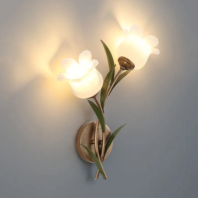 Double-head French Pastoral LED Wall Lamp with floral glass shades and brass finish, perfect for romantic living room lighting.