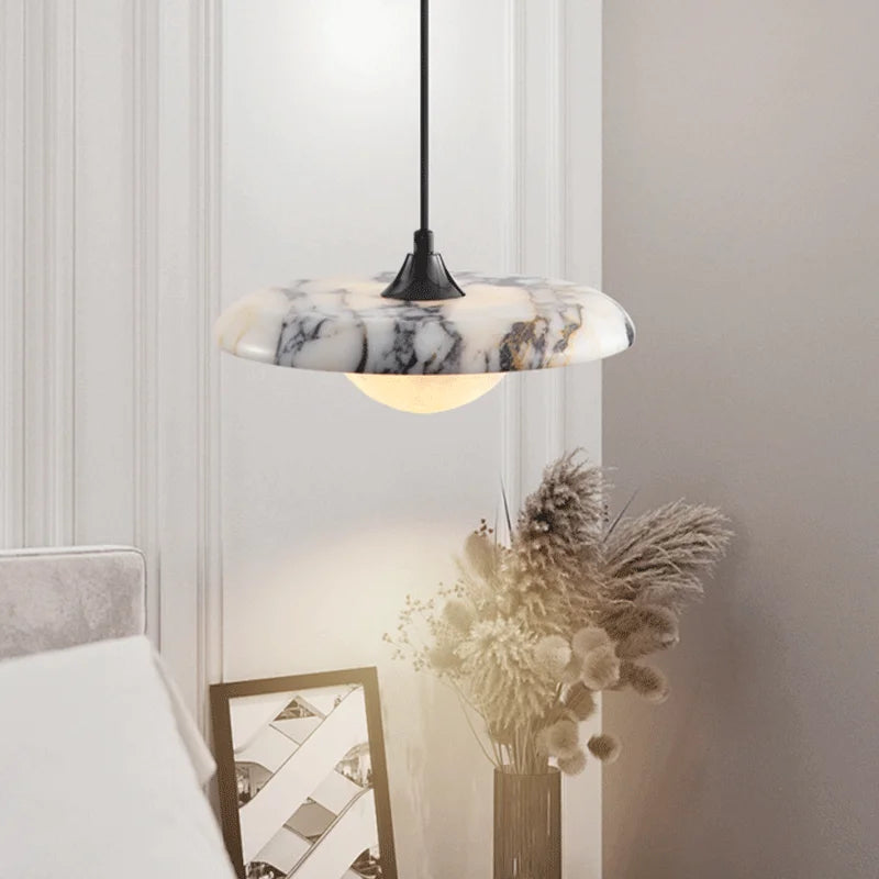 Matte Marble Pendant Lamp hanging in a stylish bedroom, showcasing its black round marble finish and ambient LED lighting.