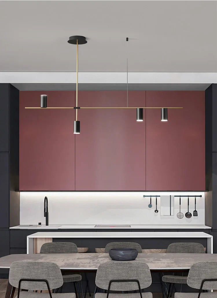 Modern kitchen with gold and black minimalist spotlight bar ceiling light, providing task lighting over a central island.