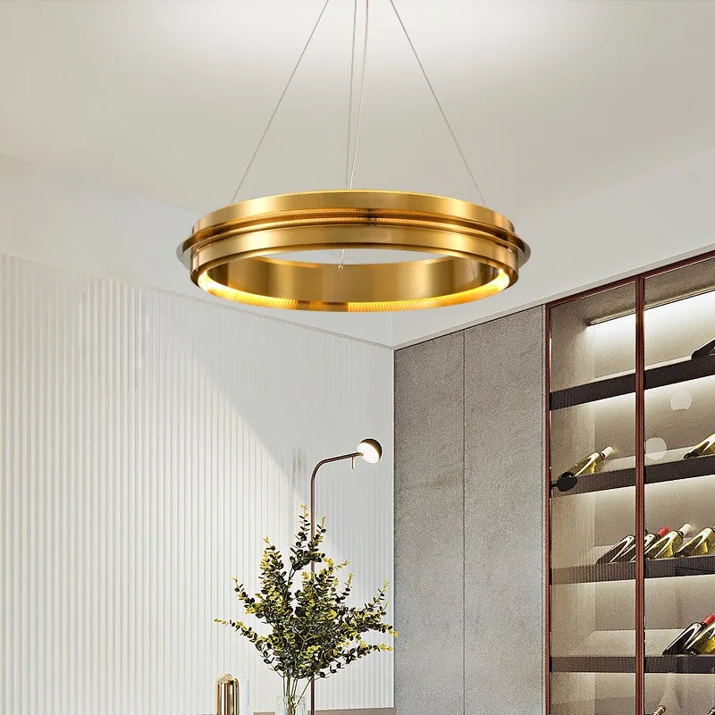 Gold LED ring chandelier suspended in a modern interior, perfect for minimalist dining or living room lighting.