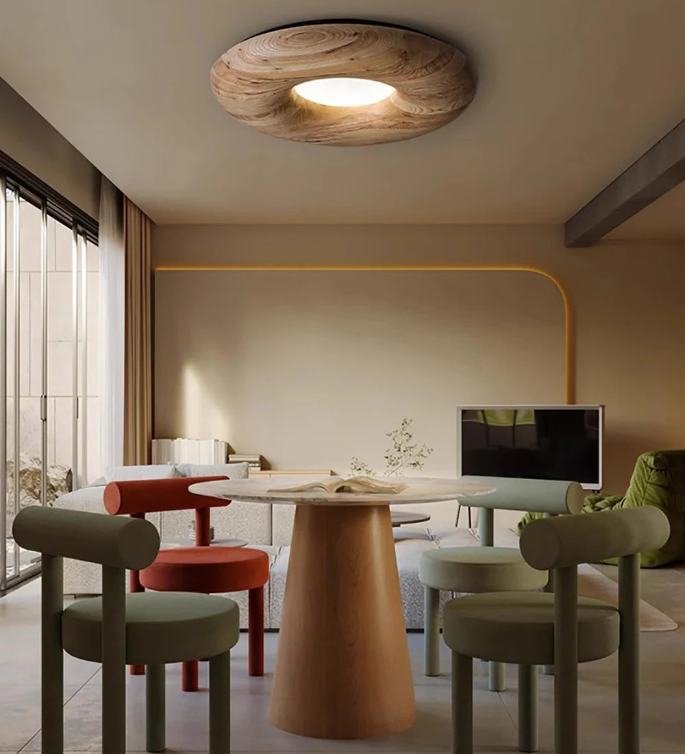 Light wood LUXELY ceiling lamp in a colorful dining room, combining modern design with cozy LED lighting for stylish gatherings.