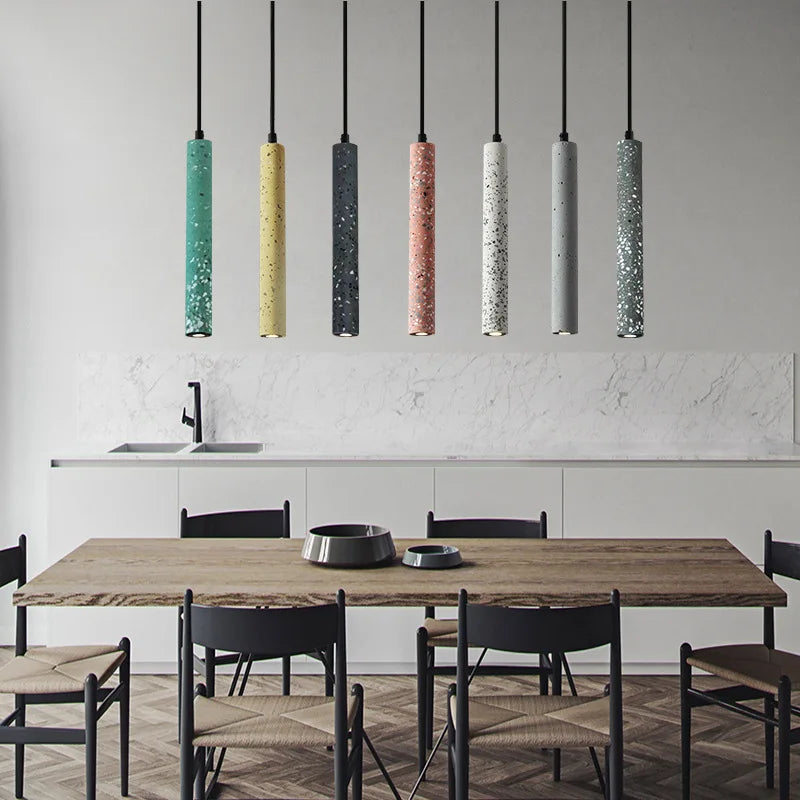 LUXELY industrial style LED pendant lights in terrazzo finish above a rustic dining table. Ideal for kitchen or dining room ambiance.