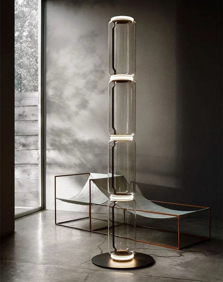 Two views of Italian glass floor lamp – modern minimalist nordic design with four-section LED-lit transparent glass body.
