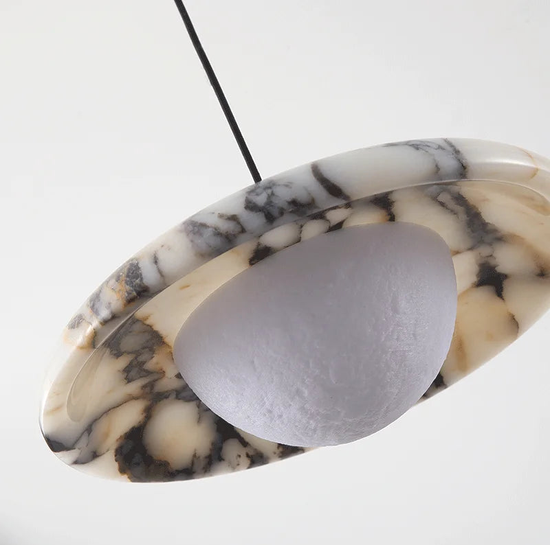 Close-up of Matte Marble Pendant Lamp showing black round marble texture and dome-shaped LED light diffuser.