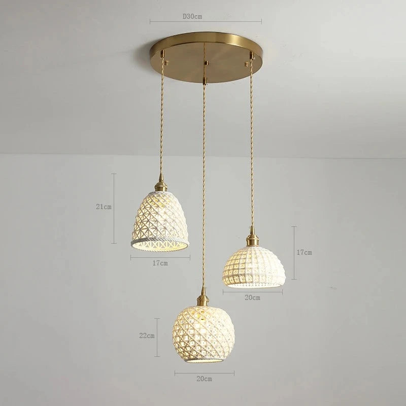 Three LUXELY ceramic pendant lights in varying shapes and sizes on a round brass mount, ideal for modern ceiling light fixtures.
