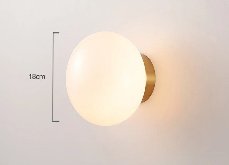 LUXELY modern wall light with brass base and 18cm diameter opal glass shade, perfect for stylish and functional home lighting.