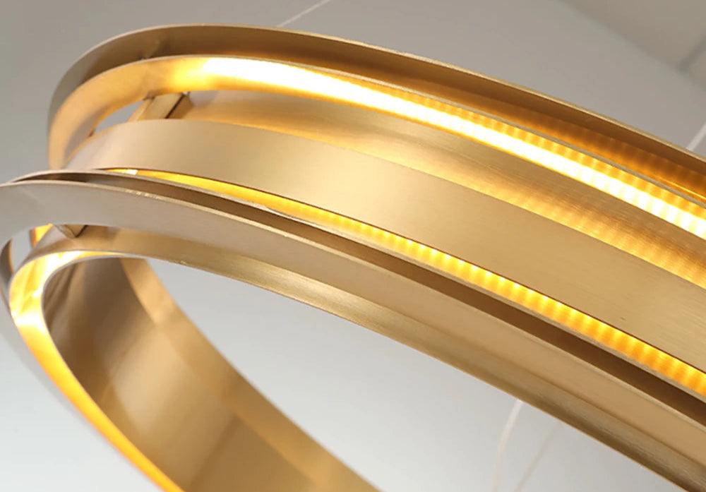 Close-up of gold LED chandelier with energy-saving chip, offering bright yet non-dazzling lighting for modern homes.