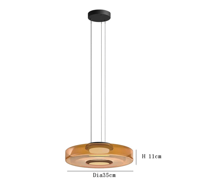 Amber glass pendant light with 35cm diameter and 11cm height. LED lighting and adjustable hanging wire for kitchen decor.