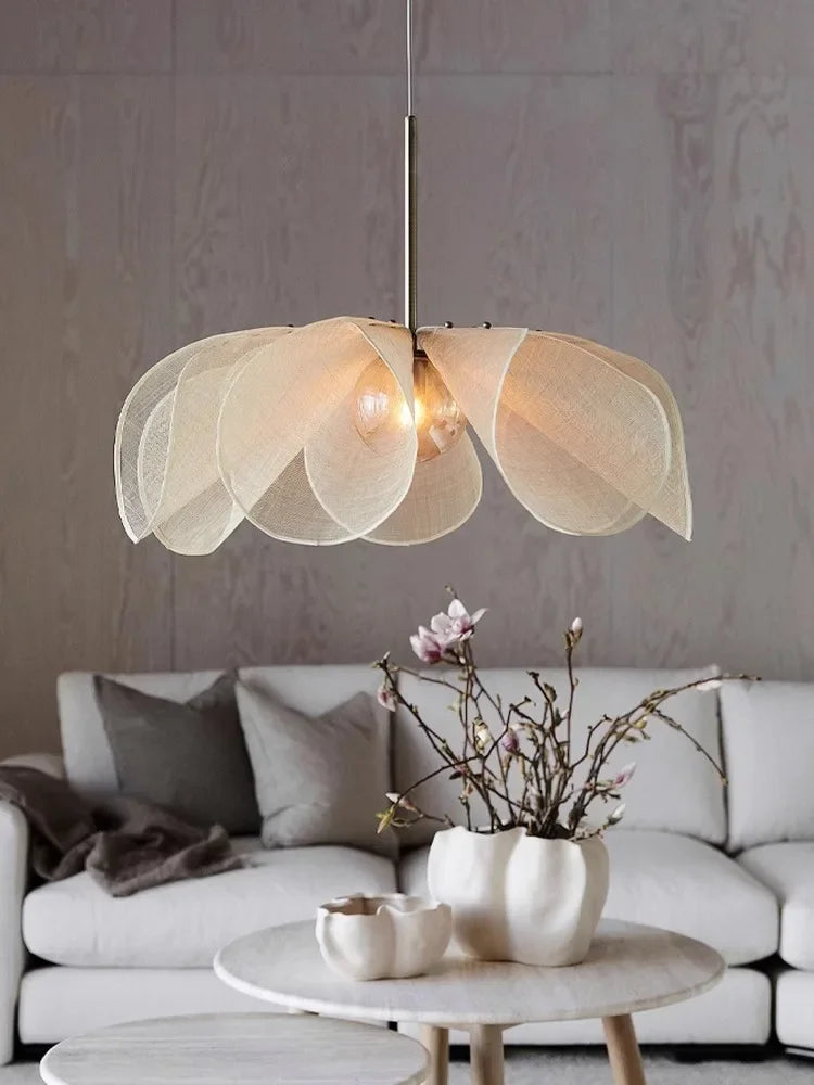Modern nordic pendant light with bubble glass chandelier design, softly illuminating a cozy living room with neutral-toned decor.