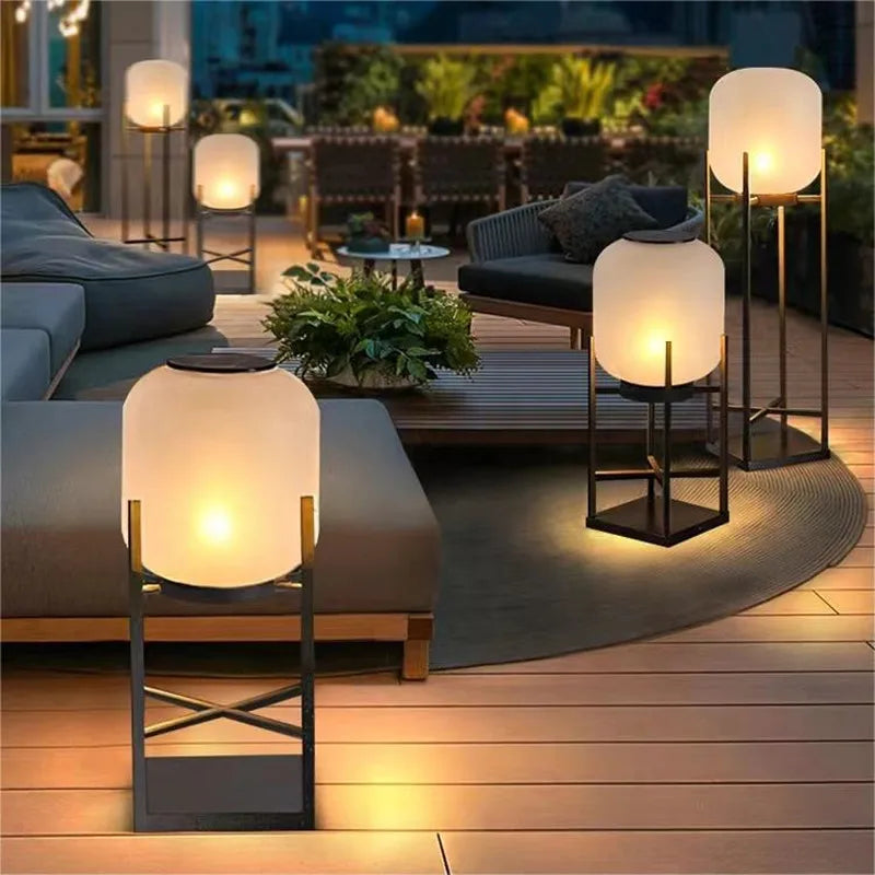LUXELY solar outdoor lights arranged on a wooden patio, enhancing villa ambiance with soft, energy-efficient lighting.