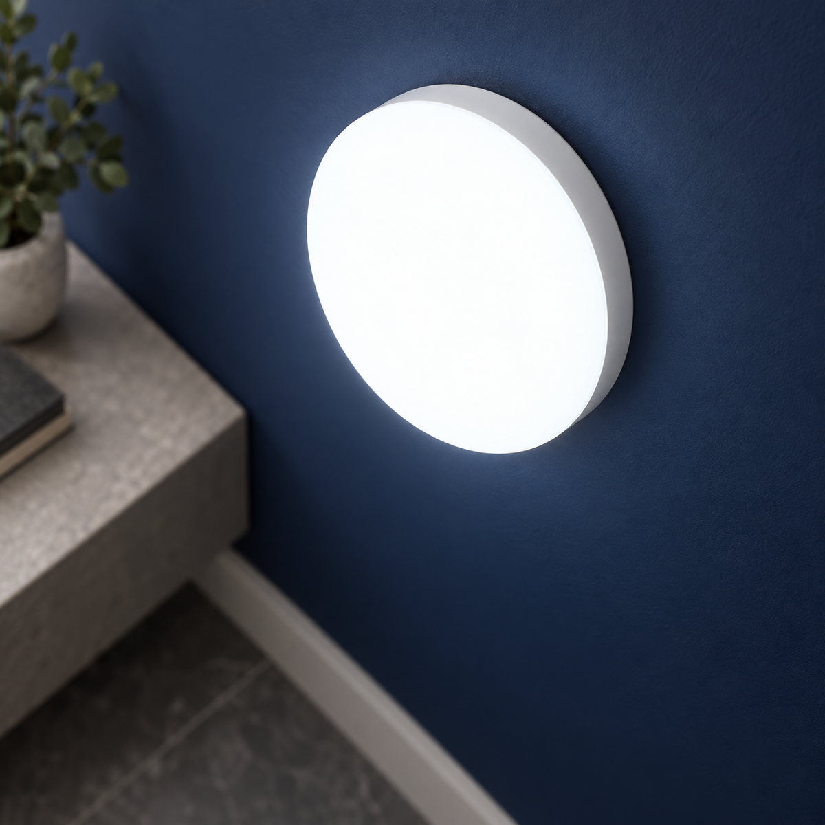 White slim round LED wall and ceiling light, medium above-angle wall-mounted view