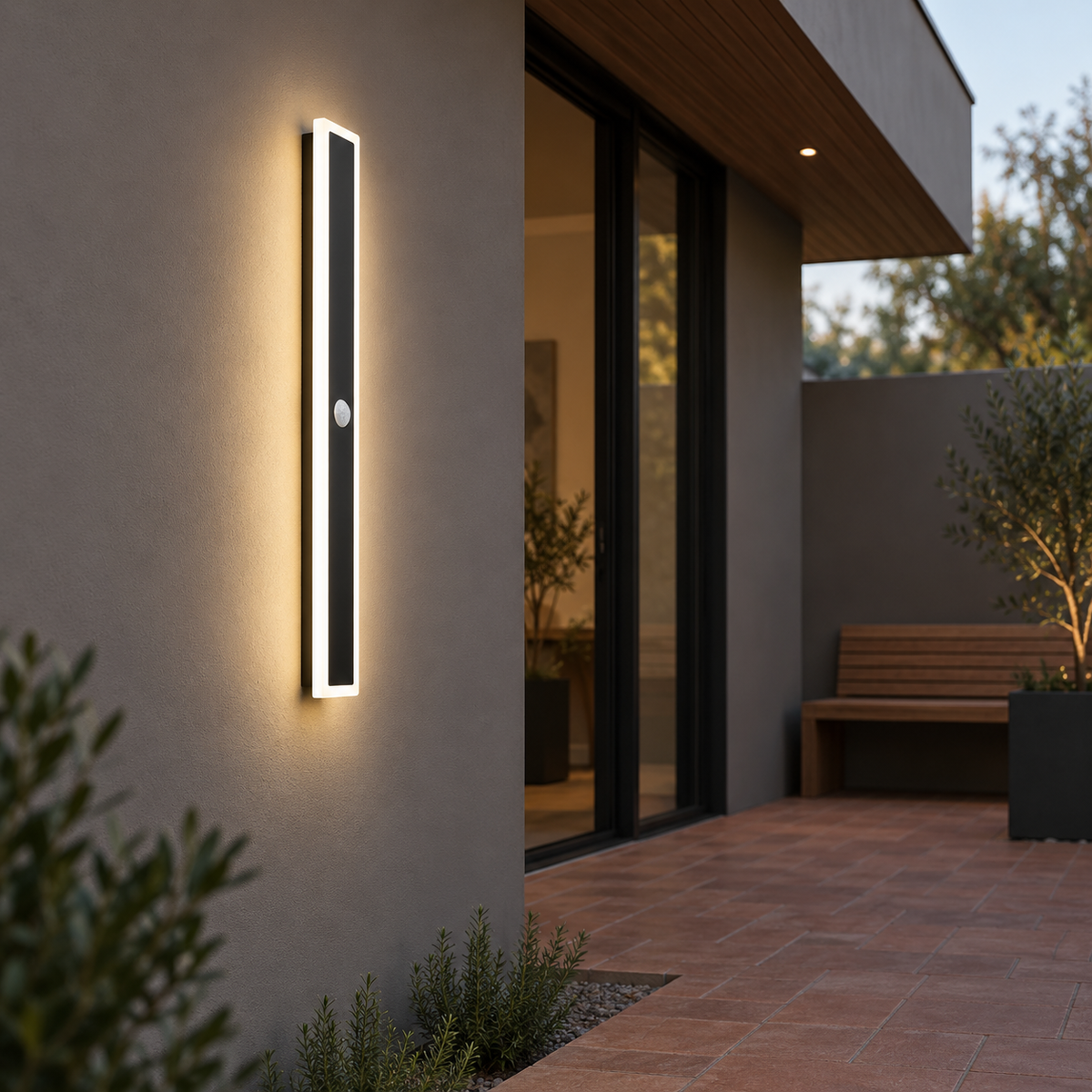 Black linear outdoor wall light with motion sensor, far side view installed outside