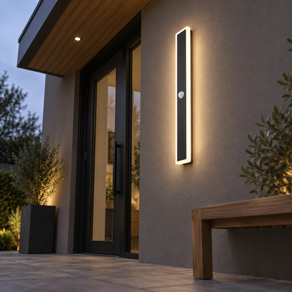 Black linear outdoor wall light with motion sensor, far underside view installed outside