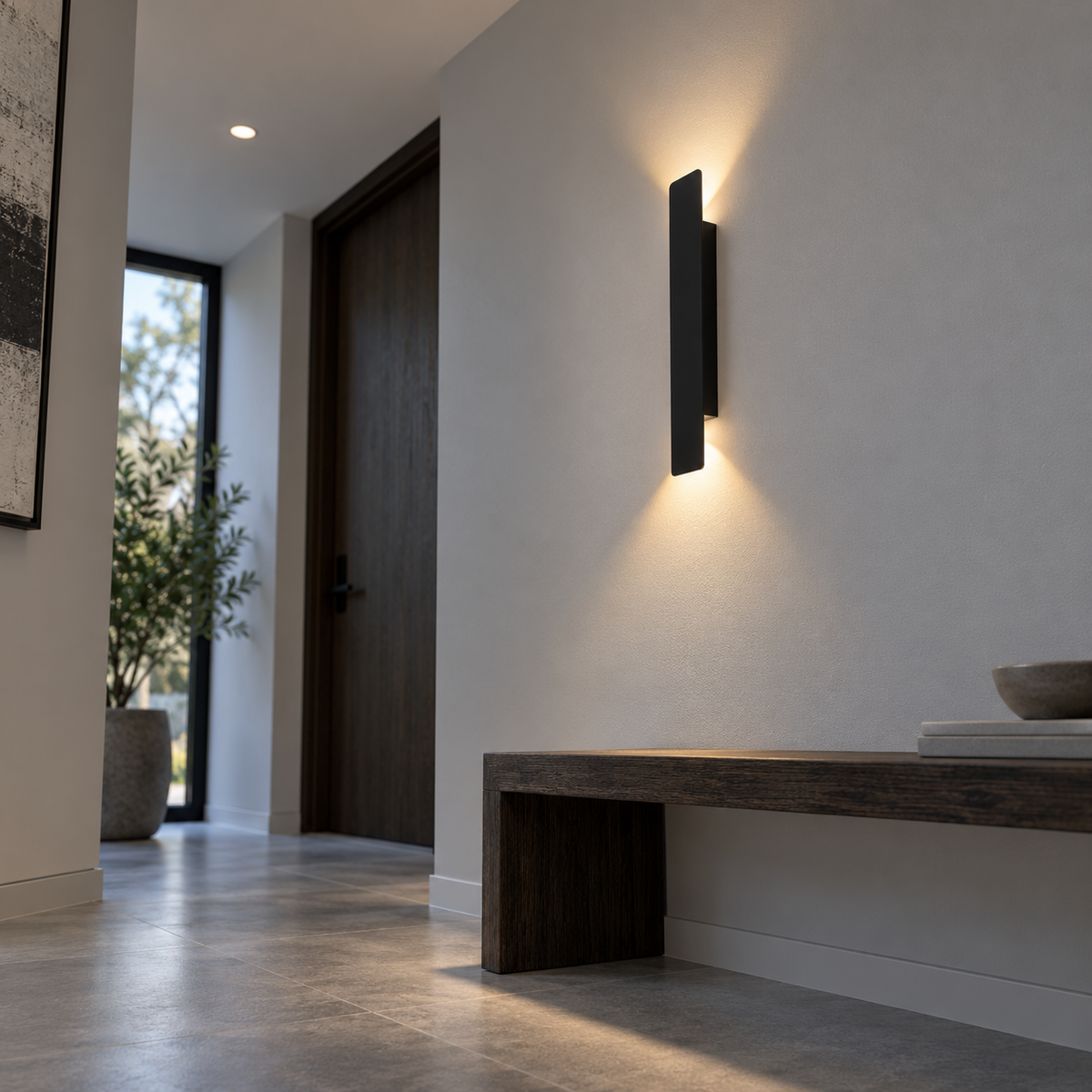 Black up and down LED bar wall light, low underside angle in a hallway