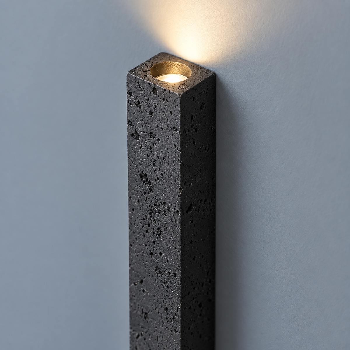 Slim black stone up and down wall light, close-up of the material and edges