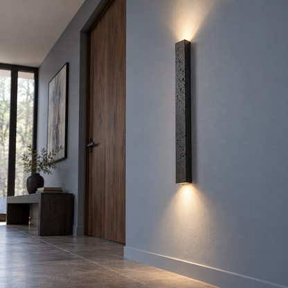 Slim black stone up and down wall light, far low underside view