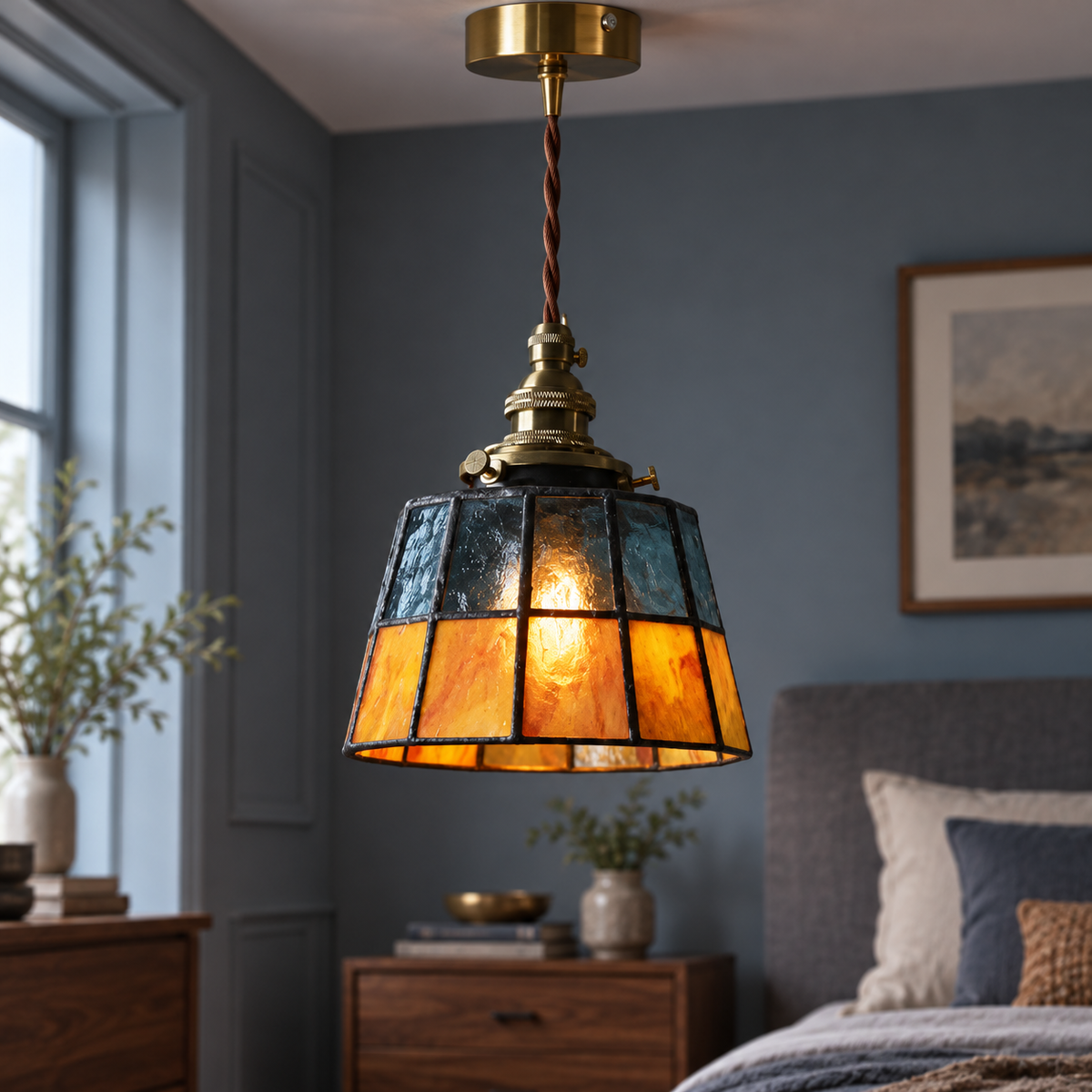 Blue and amber stained-glass pendant, centred illuminated commercial view