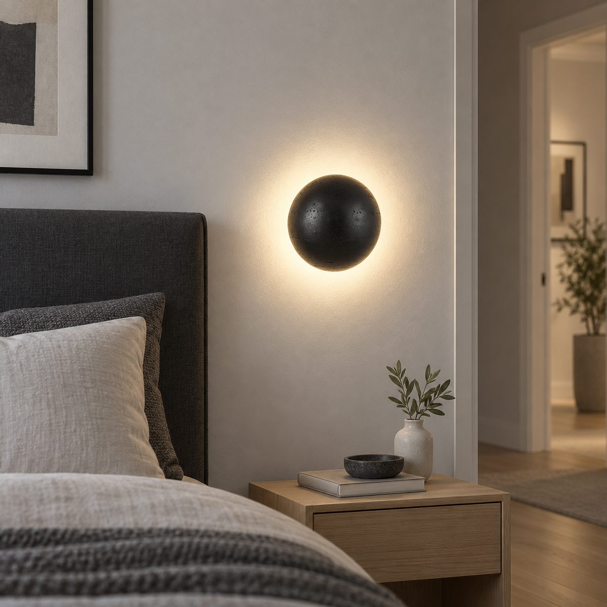 black stone dome wall light — front view installed in a modern room