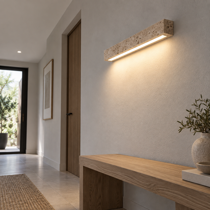 Low underside angle of the slim travertine wall light installed in a hallway