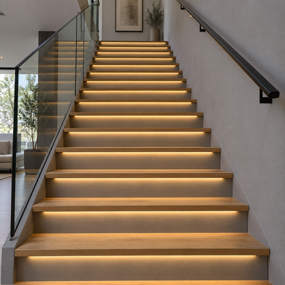 Warm white COB LED strips installed under oak stair treads, underside from distance