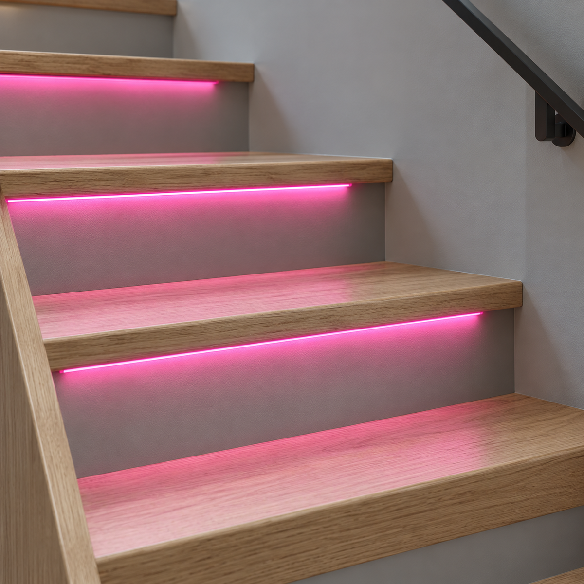 Pink COB LED stair strips installed under oak treads