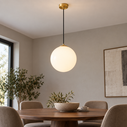 White glass globe pendant with gold fittings, low dining room view showing ceiling installation