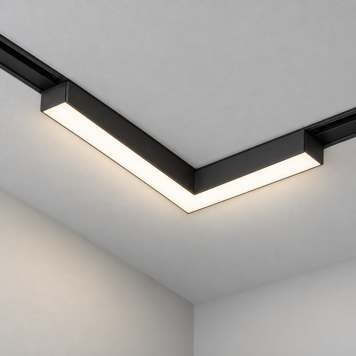Close-up of the black right-angle LED corner module installed in a ceiling track