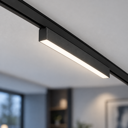 End-on close-up of a black linear LED module secured in an ultra-thin surface track