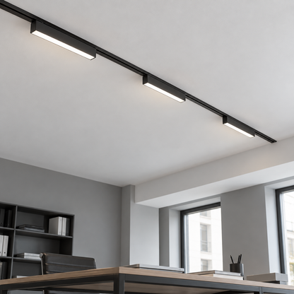 Underside view of three black linear LED modules on an ultra-thin ceiling track