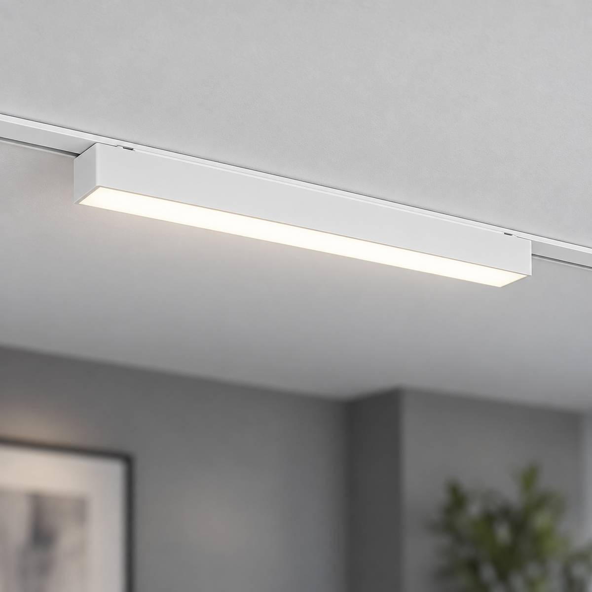 Centred white 23 cm linear LED module installed in a matching white surface rail