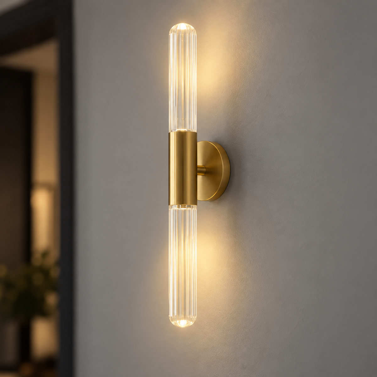 Clear glass rod LED wall light with brushed gold fitting, centered commercial view