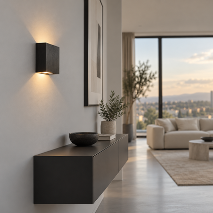 Black brushed square wall light installed in a minimalist living room, side view