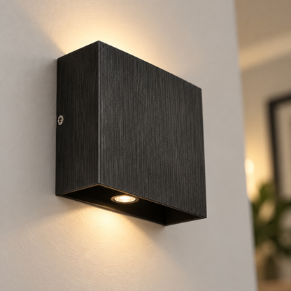 Close-up of the black brushed aluminium wall light and lower LED outlet