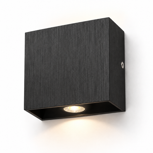Black brushed aluminium square wall light on white, with a shallow rectangular body and recessed circular LED