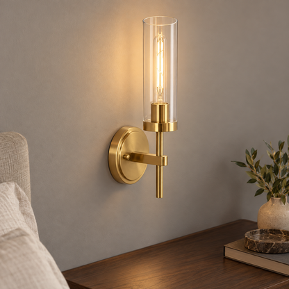Above-angle view of a gold clear glass cylinder wall light