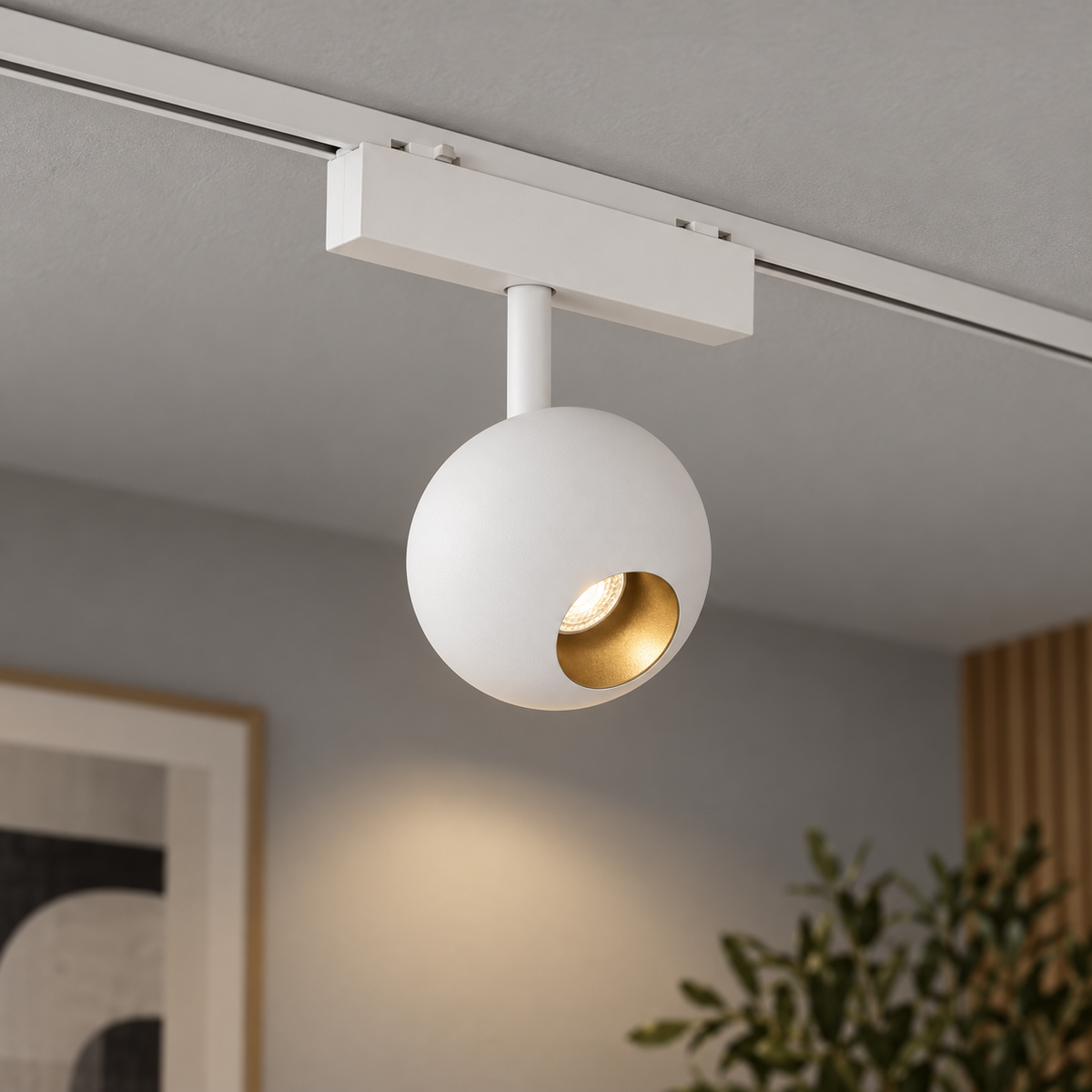 White ball magnetic track light installed on a pale-grey ceiling