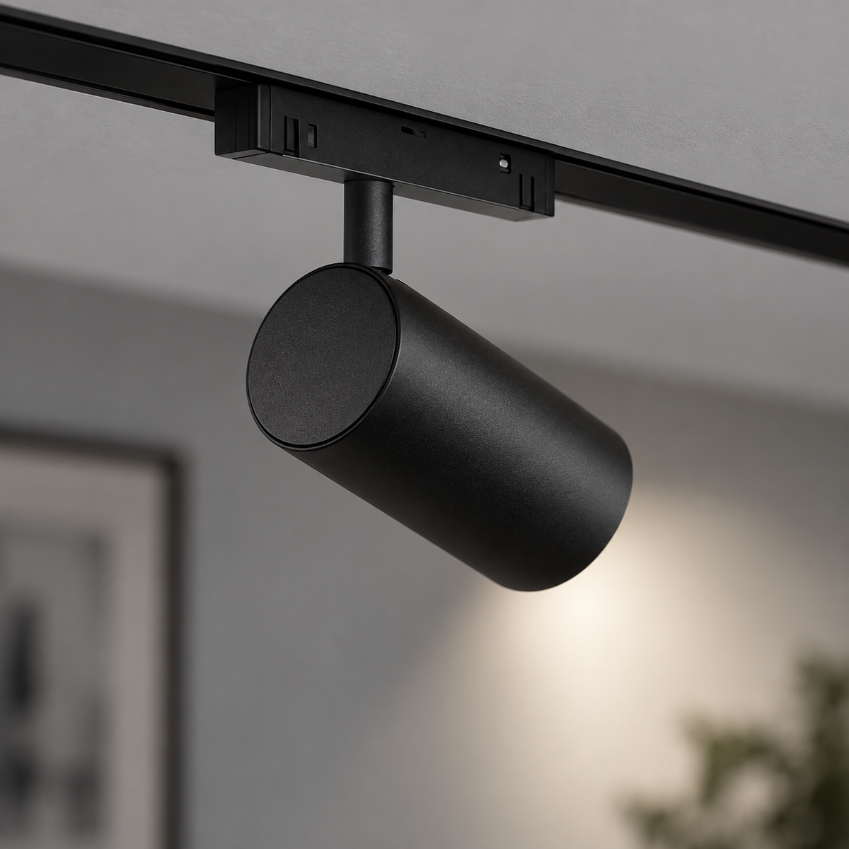 Rear-side close-up of black magnetic spotlight showing its pivot and ceiling-track mount