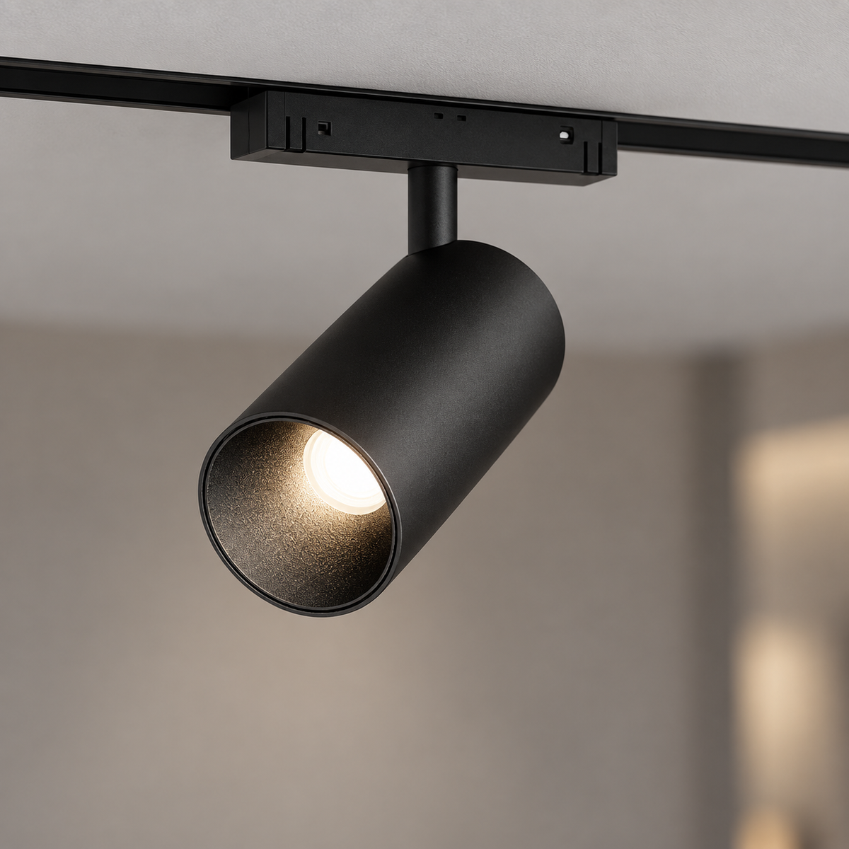 Centred black 12W magnetic spotlight installed in its matching ceiling track
