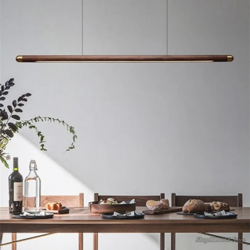 Black Walnut Pendant Light hanging above a dining table, showcasing its modern wooden design and warm LED lighting for home interiors.