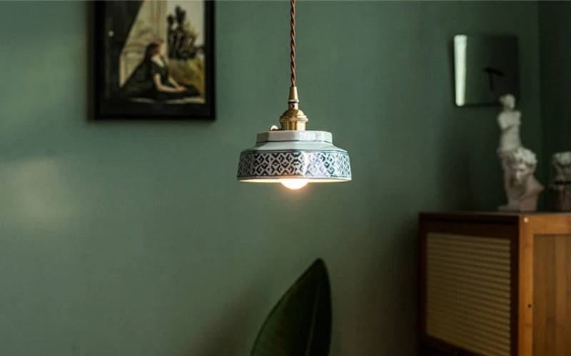Handcrafted ceramic pendant light with blue geometric pattern and LED bulb, ideal for stylish home interiors.