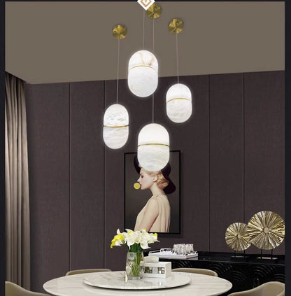 Five oval marble LED pendant lights above a dining table. Marble LED pendant light – modern ceiling lamp dimmable for dining room decor.