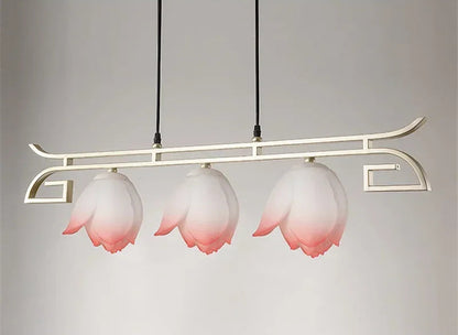 Modern lotus flower LED pendant light with three pink floral shades on a linear gold frame, perfect for vintage dining decor.